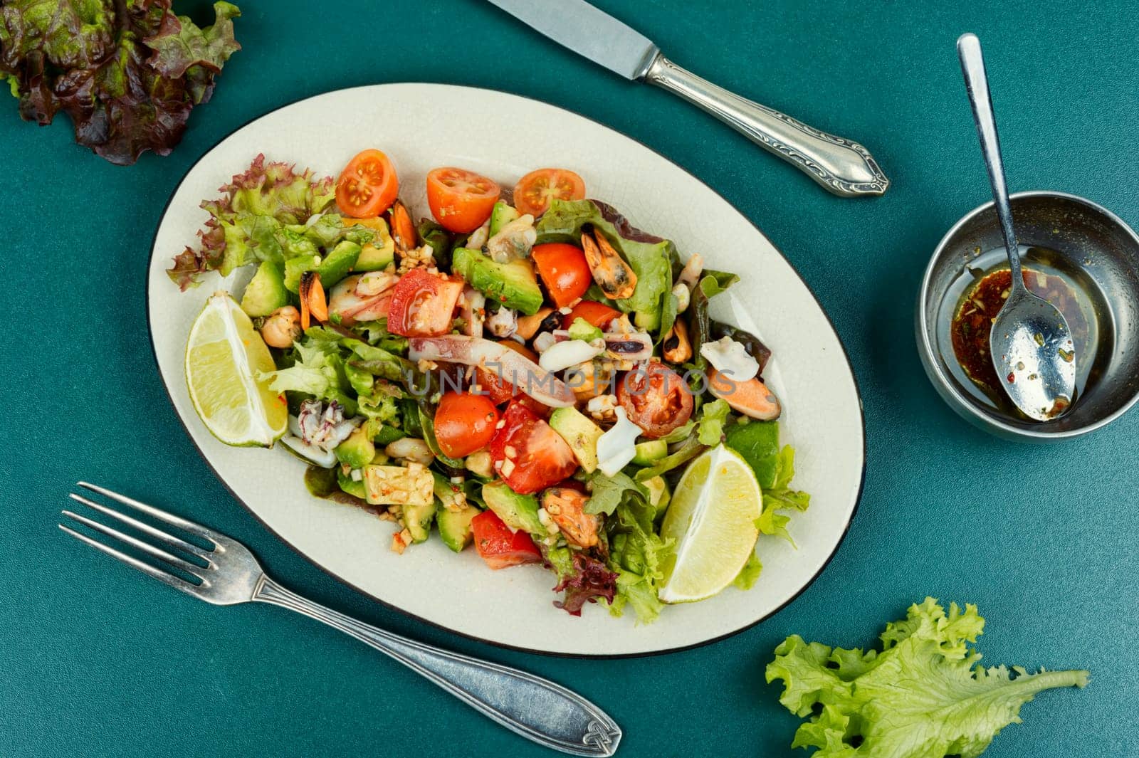 Delicious salad with fresh vegetables and seafood on a plate. Space for text.