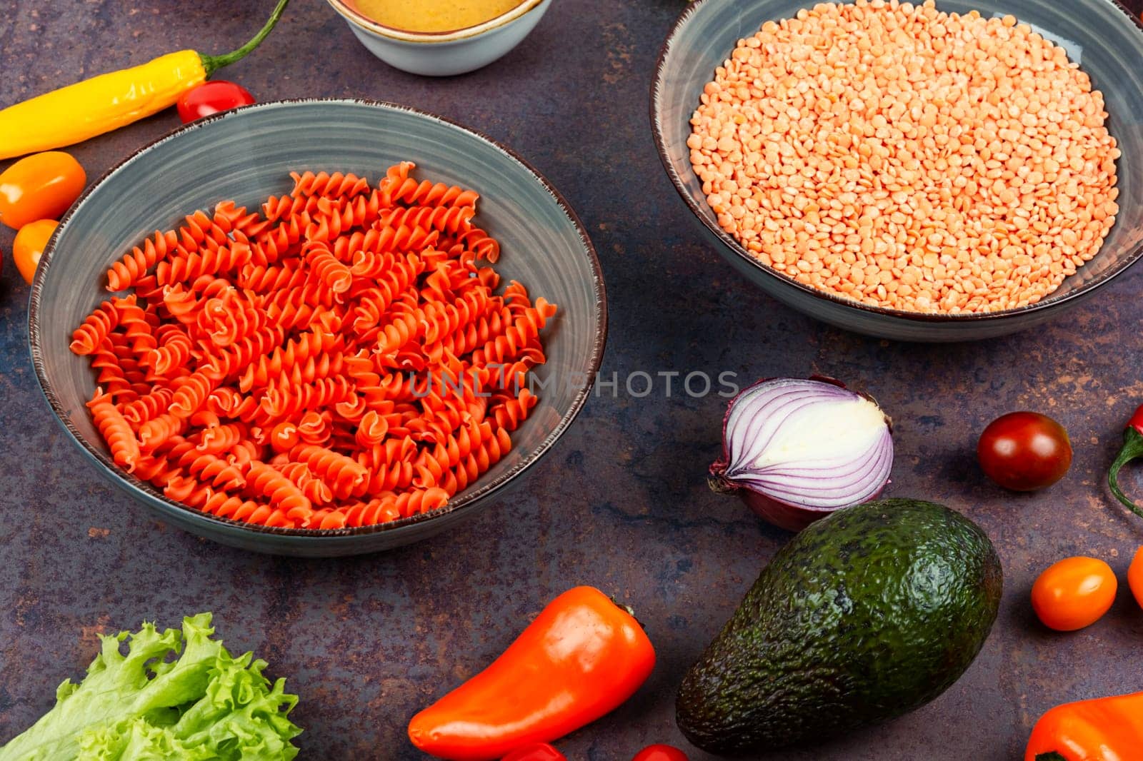 Dry red lentil fusilli pasta. Uncooked vegan pasta. Raw and dry macaroni.
