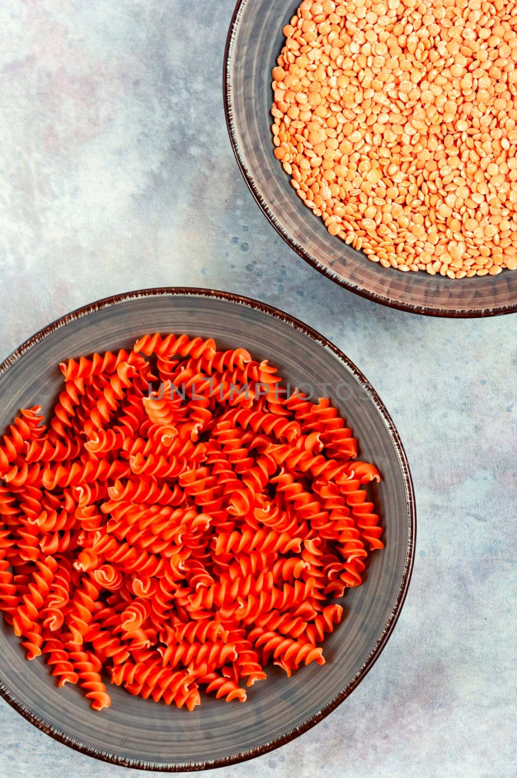 Dry red lentil fusilli pasta. Uncooked vegan pasta. Raw and dry macaroni.