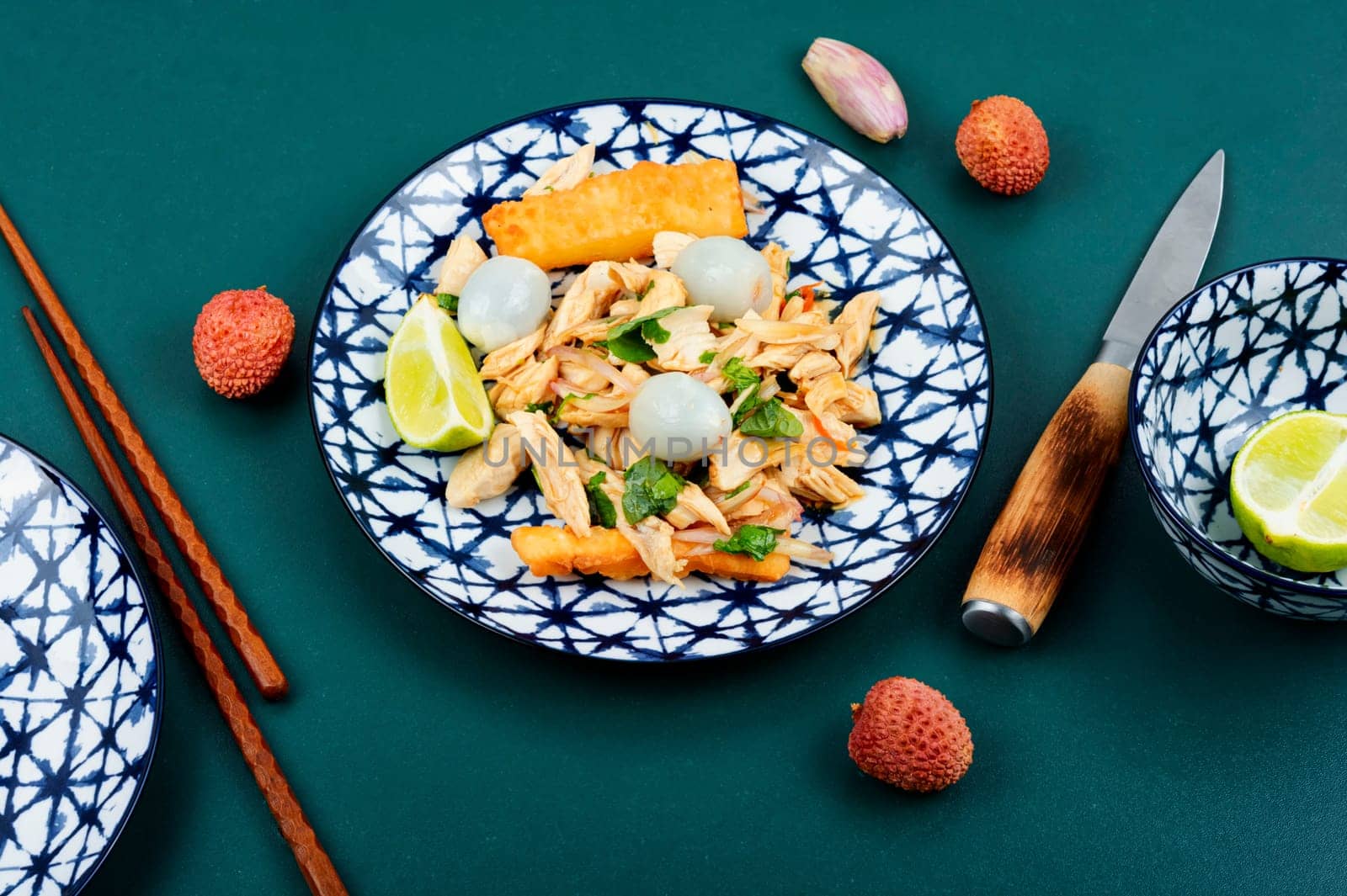 Plate of spicy Asian salad with lychee or litchi and chicken breast. Asian food. Top view.