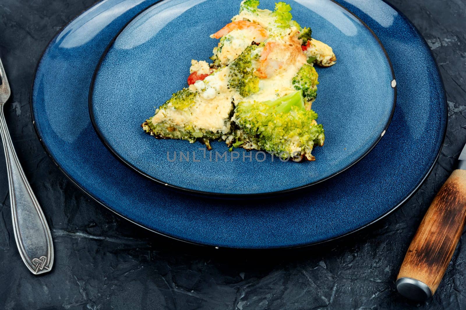 Roasted omelet with broccoli, cooked shrimp and tomato. Ketogenic lunch.