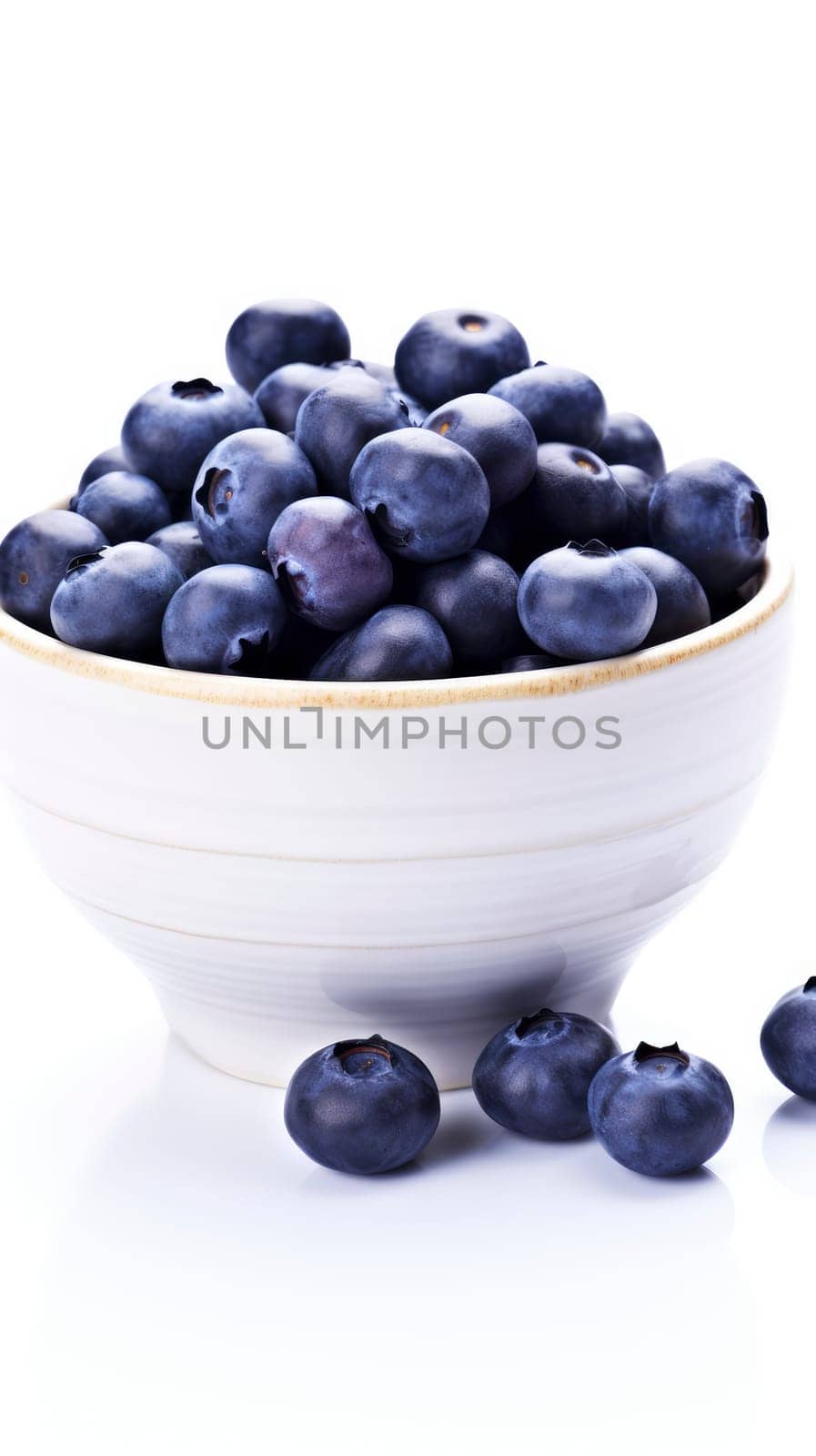 A refreshing image of a white bowl brimming with juicy blueberries, enticingly displayed on a table.