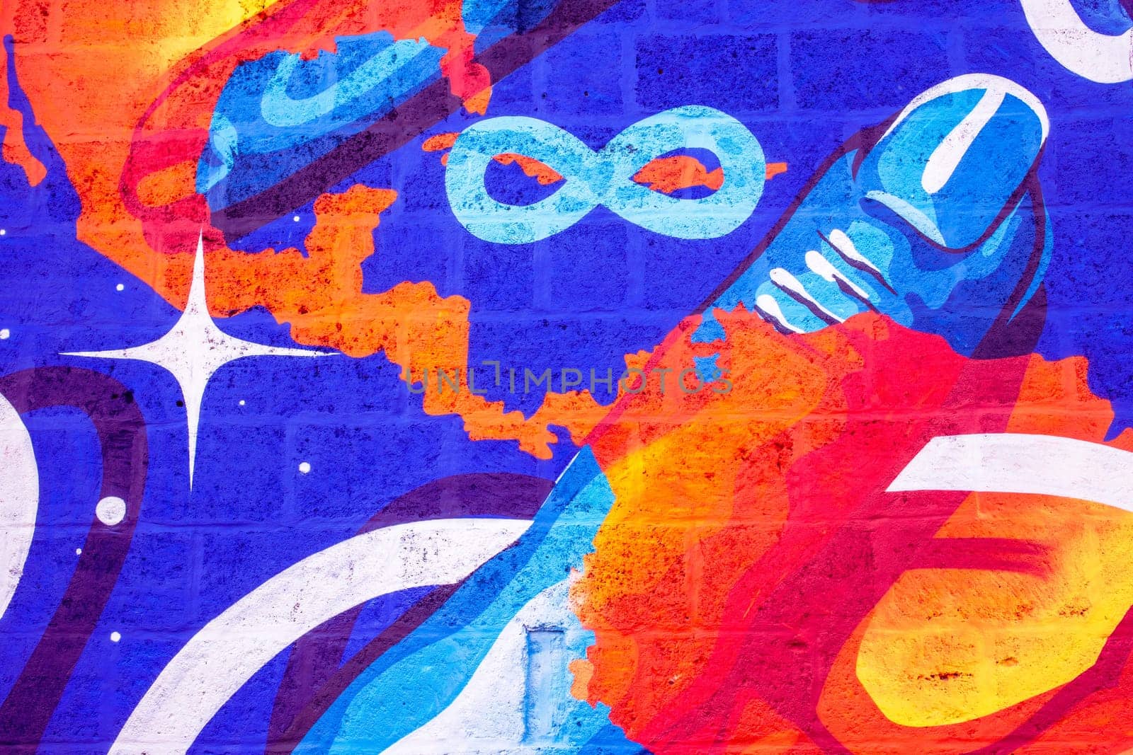 Detail of a blue graffiti fingr on a wall, abstract background