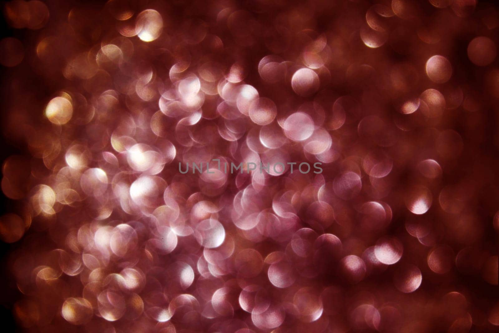Black background with lots of red and gold dots of light