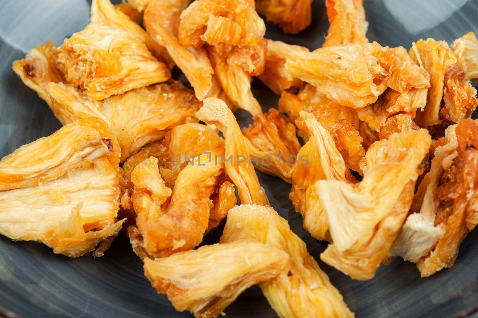Delicious dry and fresh pineapples in bowls. Candy pineapples or ananas.