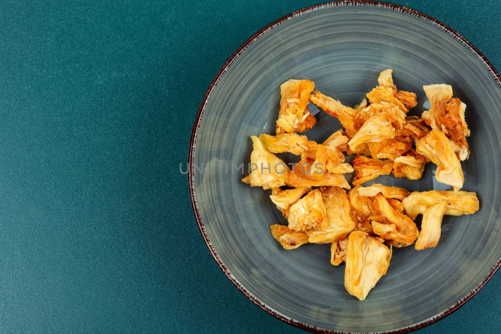 Delicious dry and fresh pineapples in bowls. Candy pineapples or ananas.