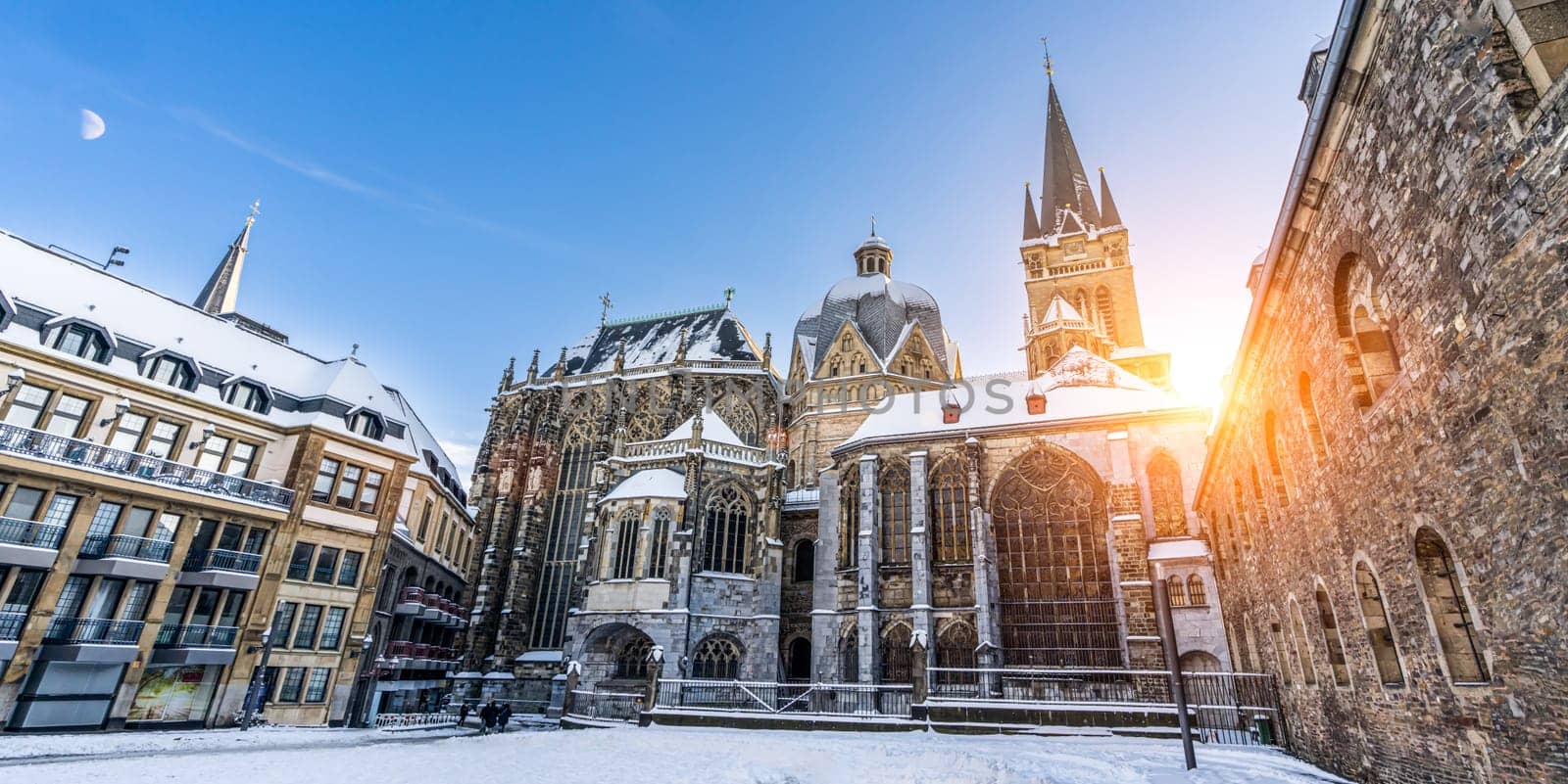 The famous Huge gothic cathedral of The Emperor Karl in Aachen Germany during winter season with snow at Katschhof against blue sky and sunshine background