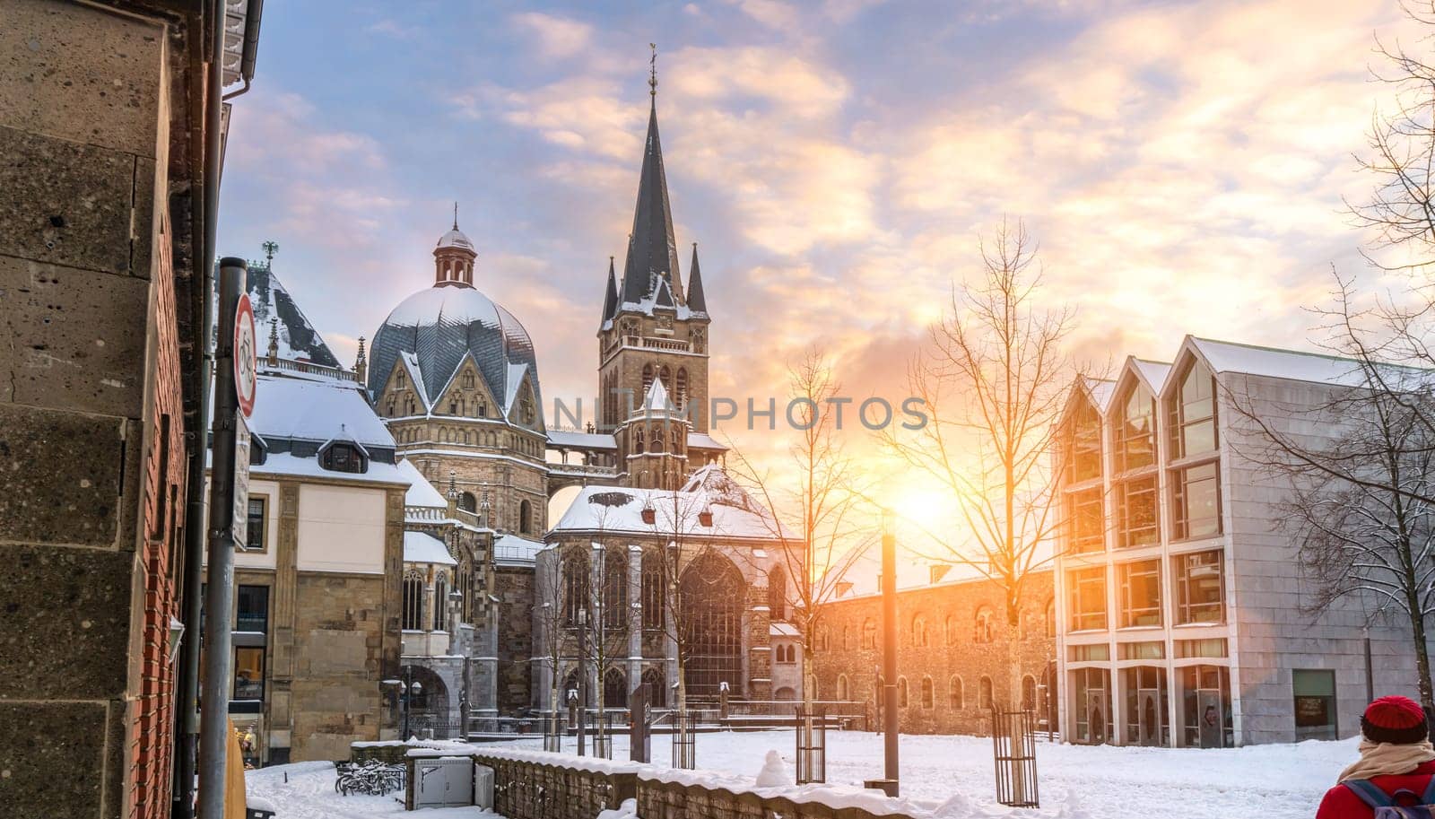The famous Huge gothic cathedral of The Emperor Karl in Aachen Germany during winter season with snow at Katschhof against blue sky and sunshine background
