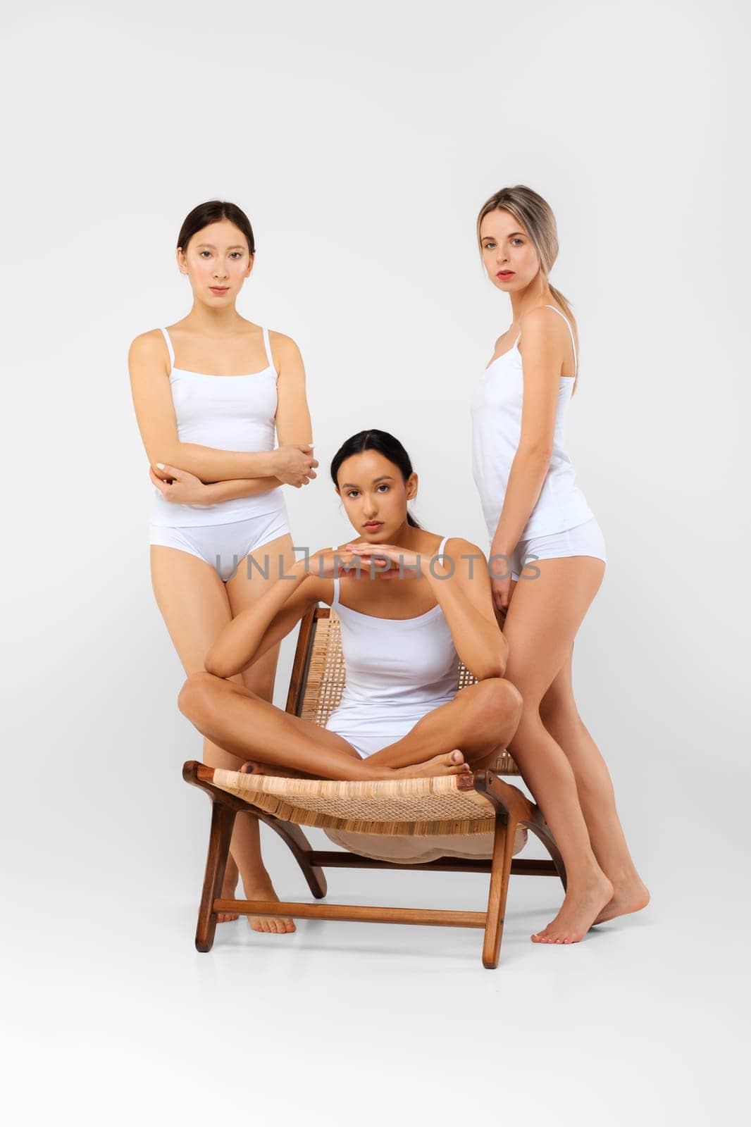 Multi-ethnic group of women in bright white studio. Natural beauty concept.