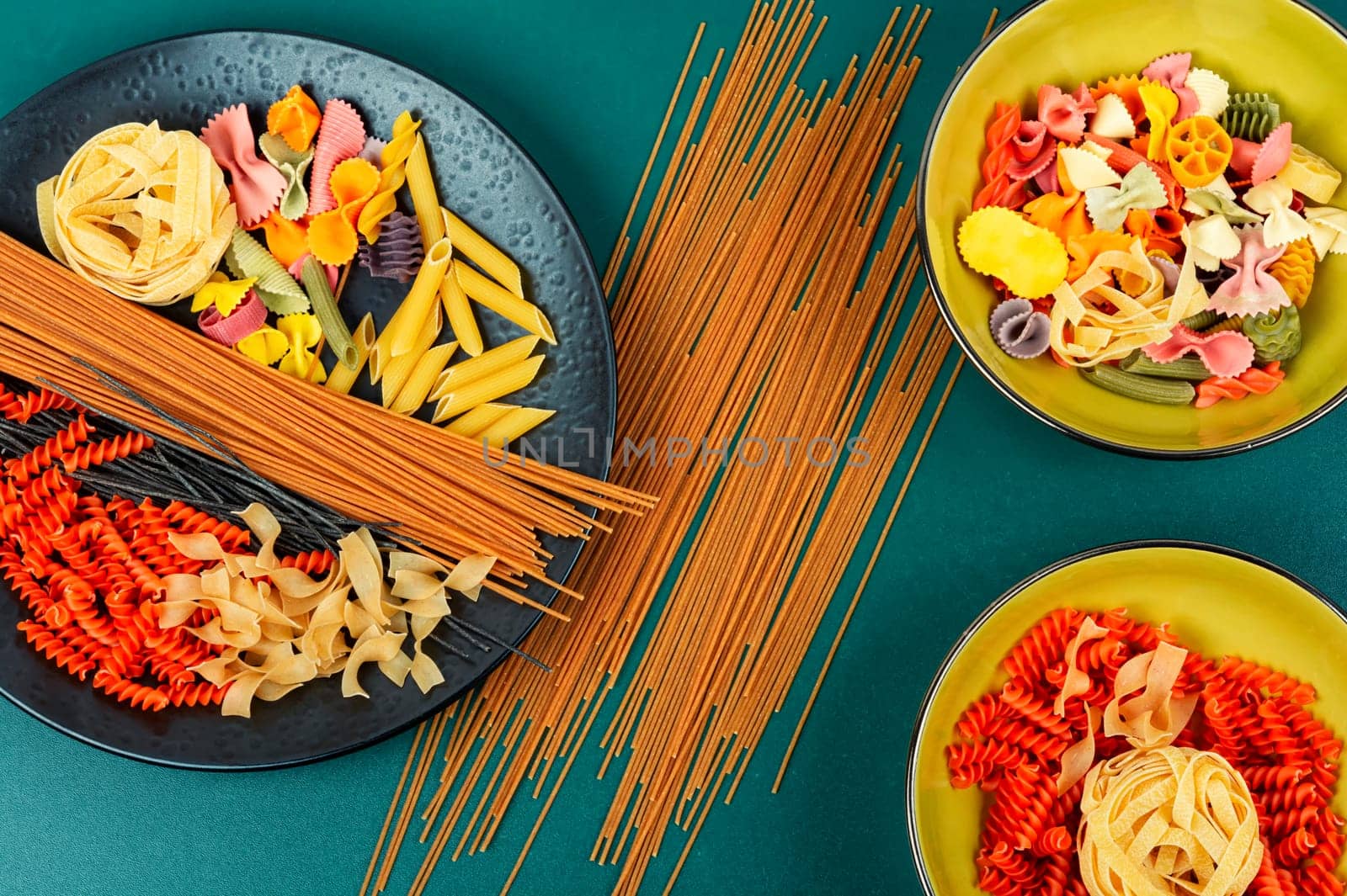 Different sorts of uncooked pasta, macaroni, noodles and spaghetti.
