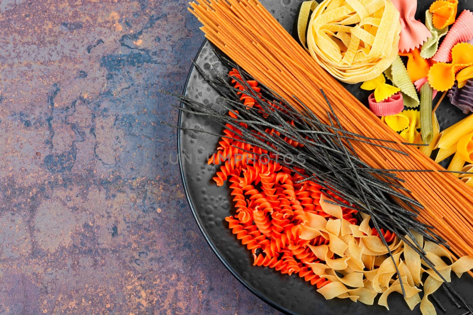Different sorts of uncooked pasta, macaroni, noodles and spaghetti.