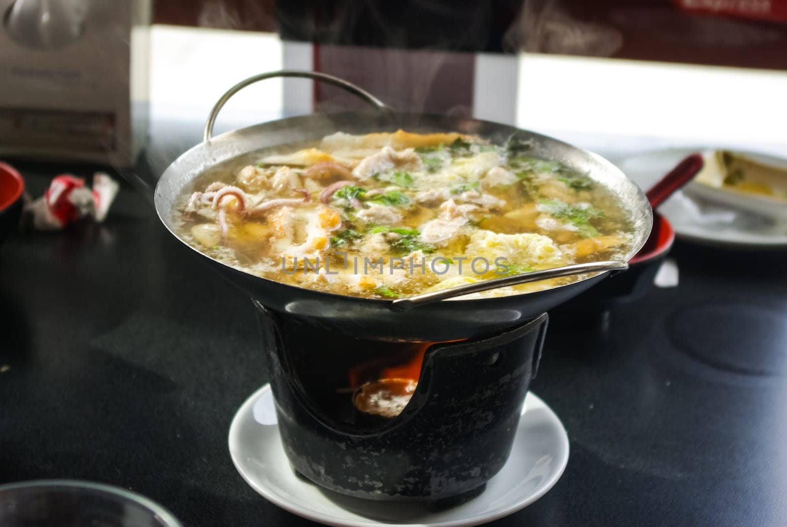 Seafood soup. Octopus in soup in the dining room.