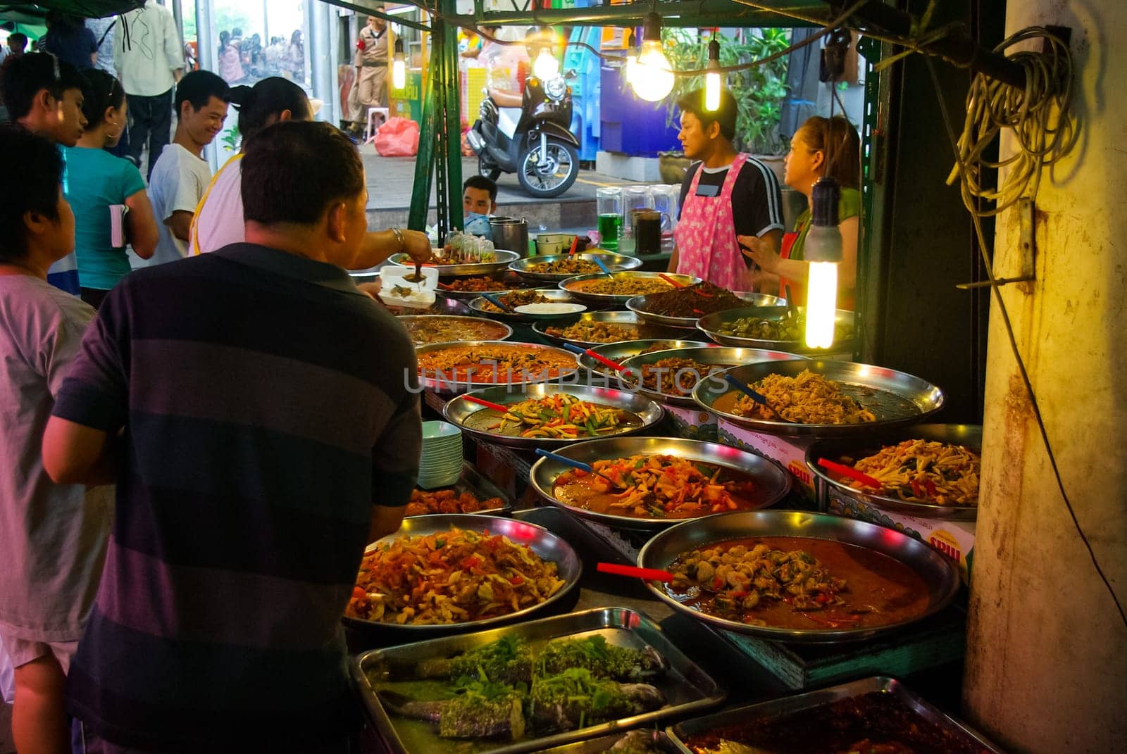 Bangkok, Thailand - August 24, 2018: Shop on the market in Bangkok, people sell fruit and seafood.