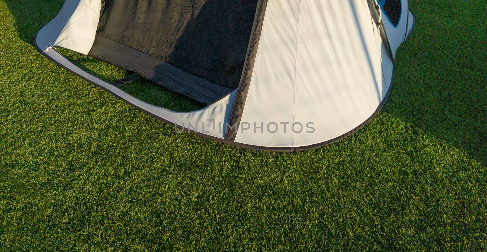 Iglu tents installed on artificial grass. Sunny natural light