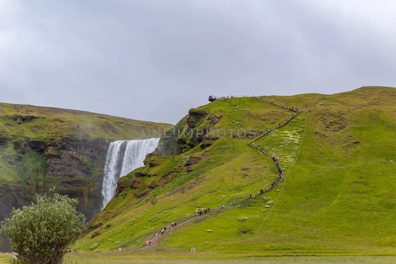 Skogar Iceland - July 28, 2023: Tourists visiting Skogafoss waterfall in south Iceland