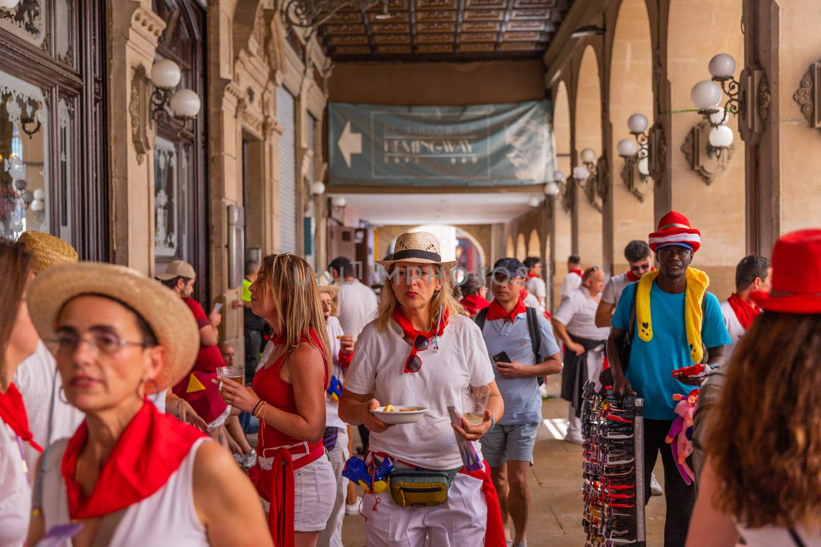 Pamplona, Spain: 09 July 2023: People celebrate San Fermin festival in traditional white abd red clothing with red necktie, Pamplona, Navarra, Spain.