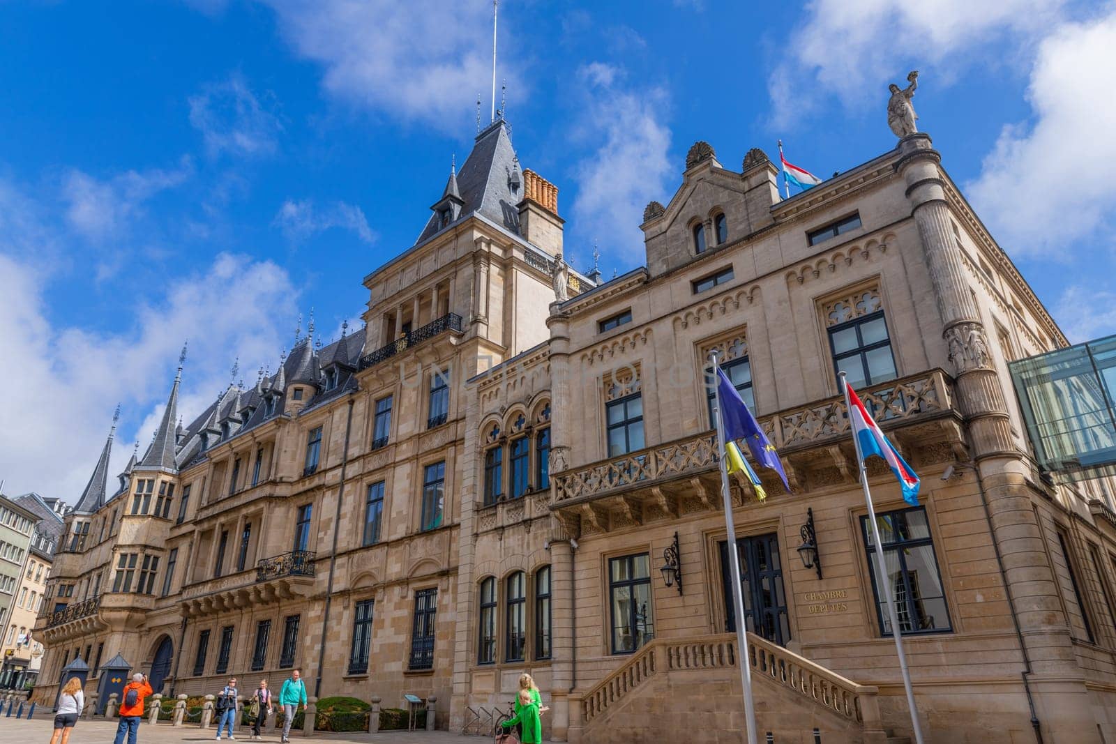 Luxembourg - 01 August 2023: Tourists walking in front of Palais Grand-Ducal official residence of the Grand Duke of Luxembourg