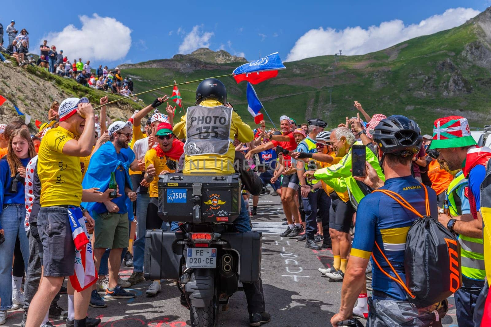 Col du Tourmalet, France - July 06 2023: Cycling fans waiting for the buch at the top of the Col du Tourmalet in Pyerenees mountains during the stage 6 of Le Tour de France 2023