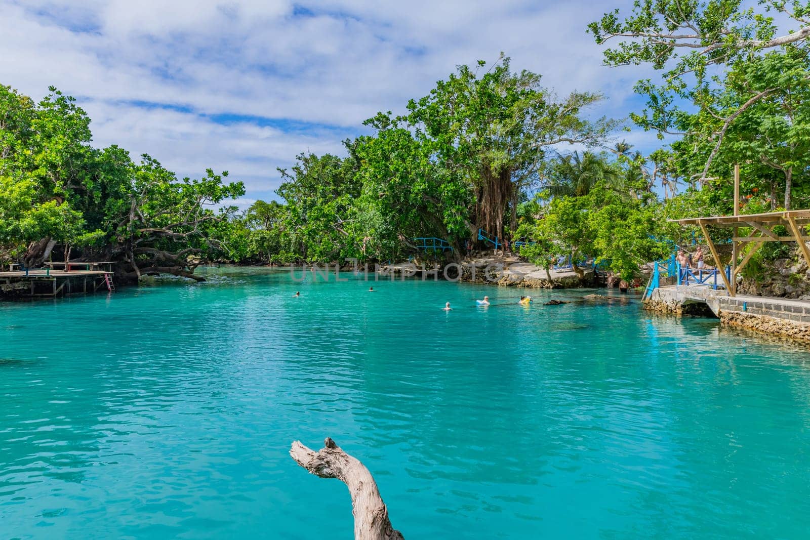 Port Vila, Vanuatu: 01 June 2023: People swimming in Blue Lagoon, a popular scenic turquoise swimming hole near Port Vila, Efate Island, Vanuatu, Melanesia