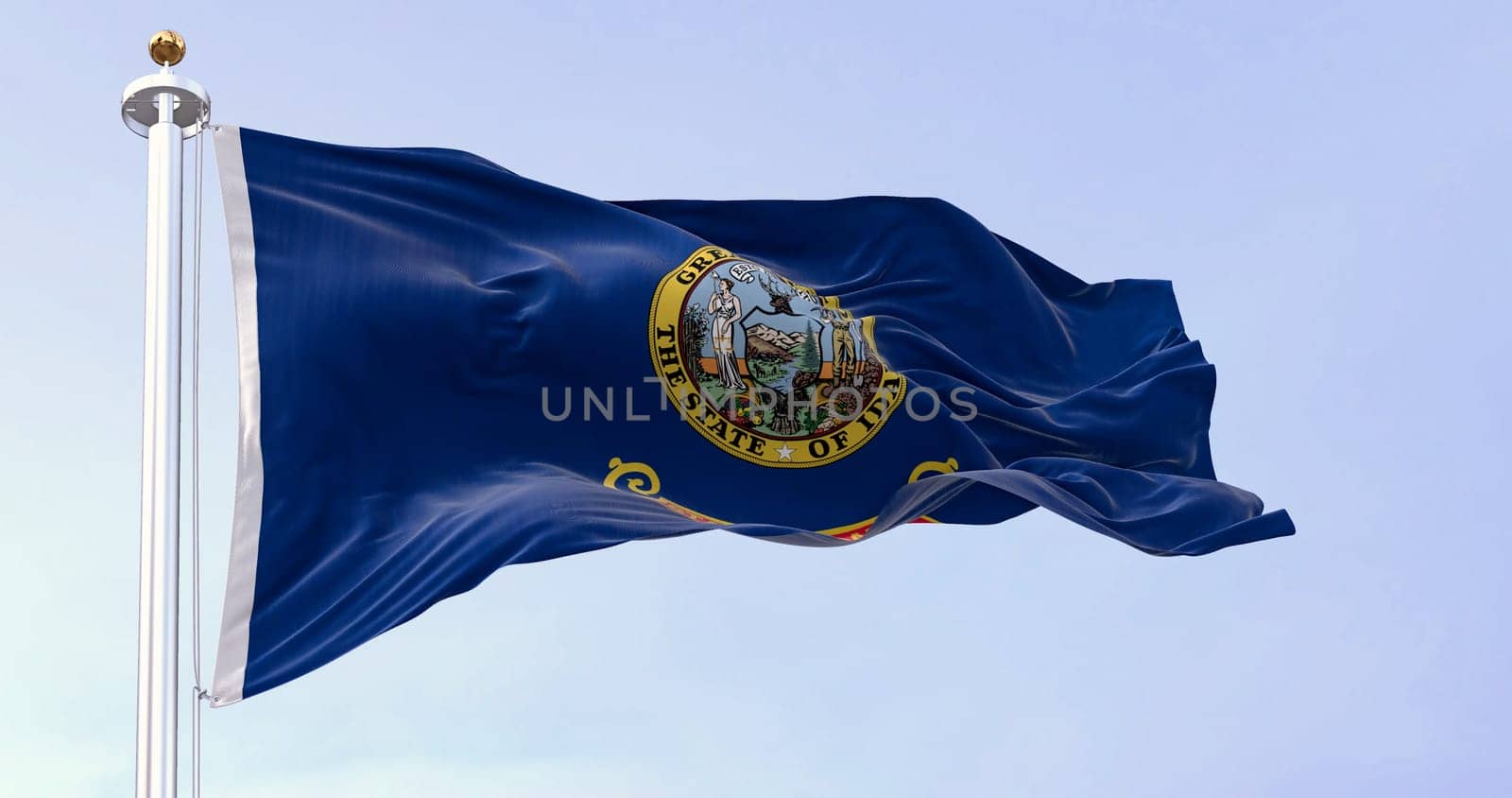 Idaho state flag fluttering in the wind. Blue background with the state seal and a red band with State of Idaho in gold text. 3d illustration render. Selective focus. Close-up