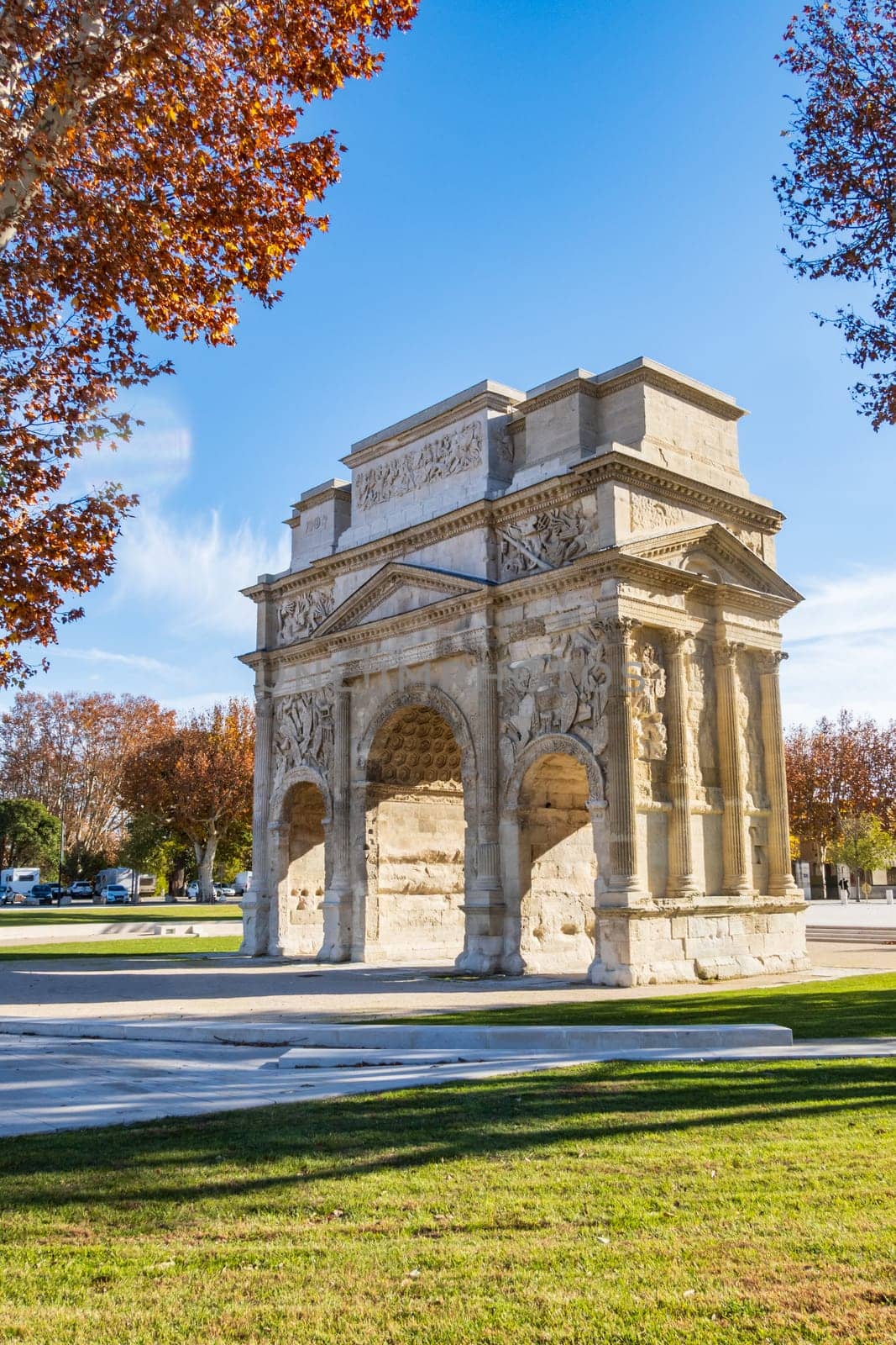 Orange, France - November 29 2023: Roman triumphal arch, historical memorial building in Orange city, in the Provence-Alpes-Côte d'Azur region. Vertical photography taken in France