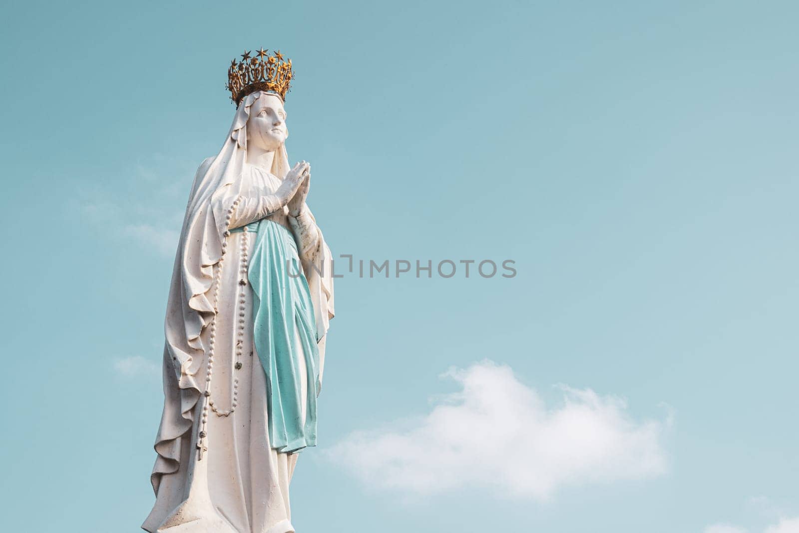 Lourdes, France - August 28, 2021: Sculpture of the crowned Virgin Mary in the Sanctuary of Lourdes, France. Place of worship and pilgrimage for christians