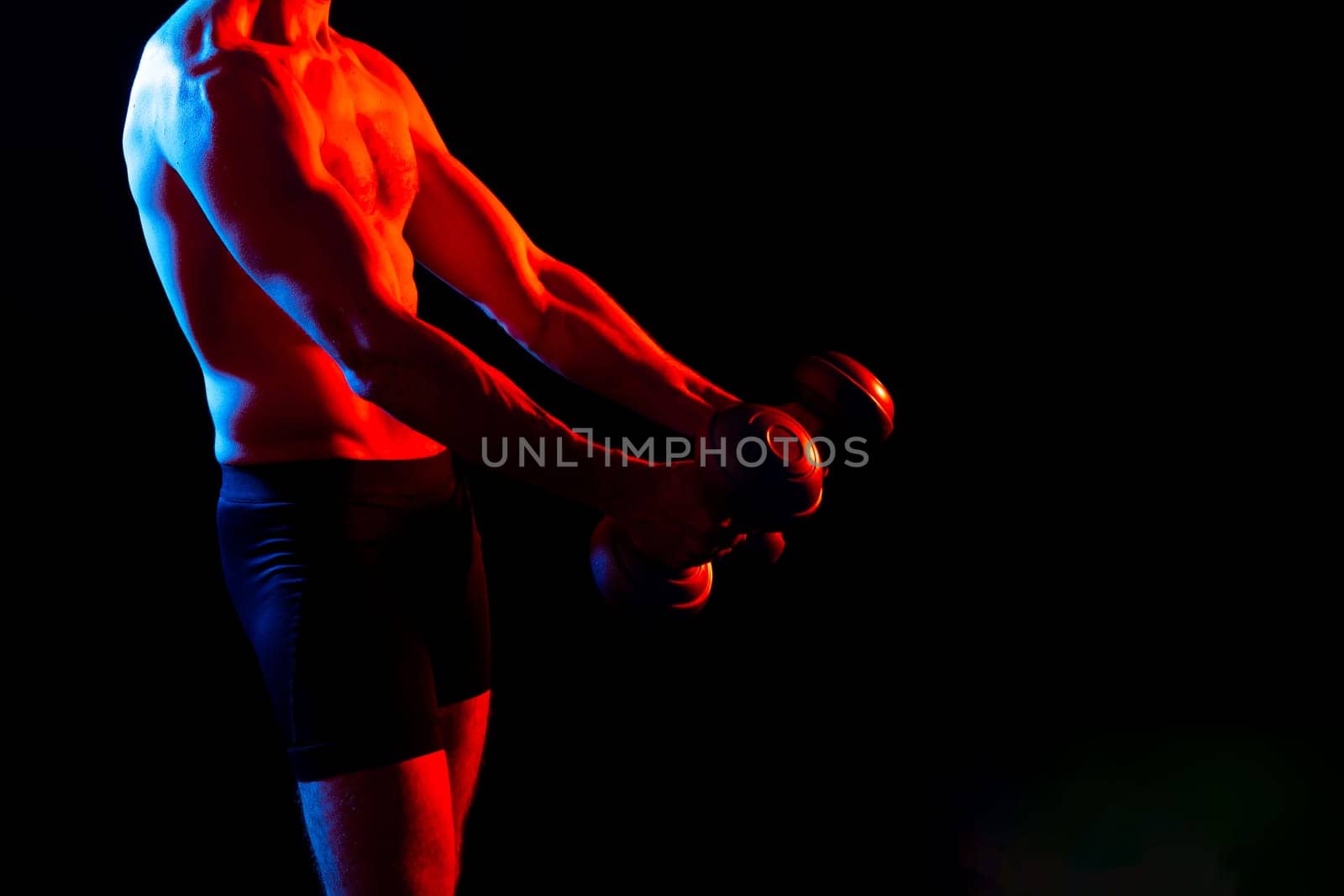 Man, dumbbell and exercise in a studio for fitness, wellness and healthy body with workout training.