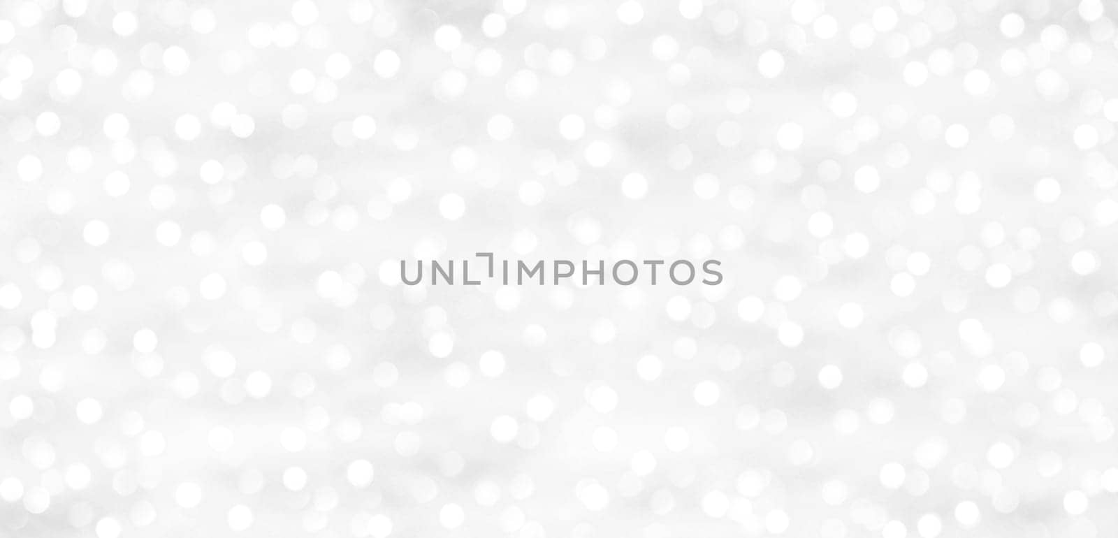 A glittering white background with dots of light