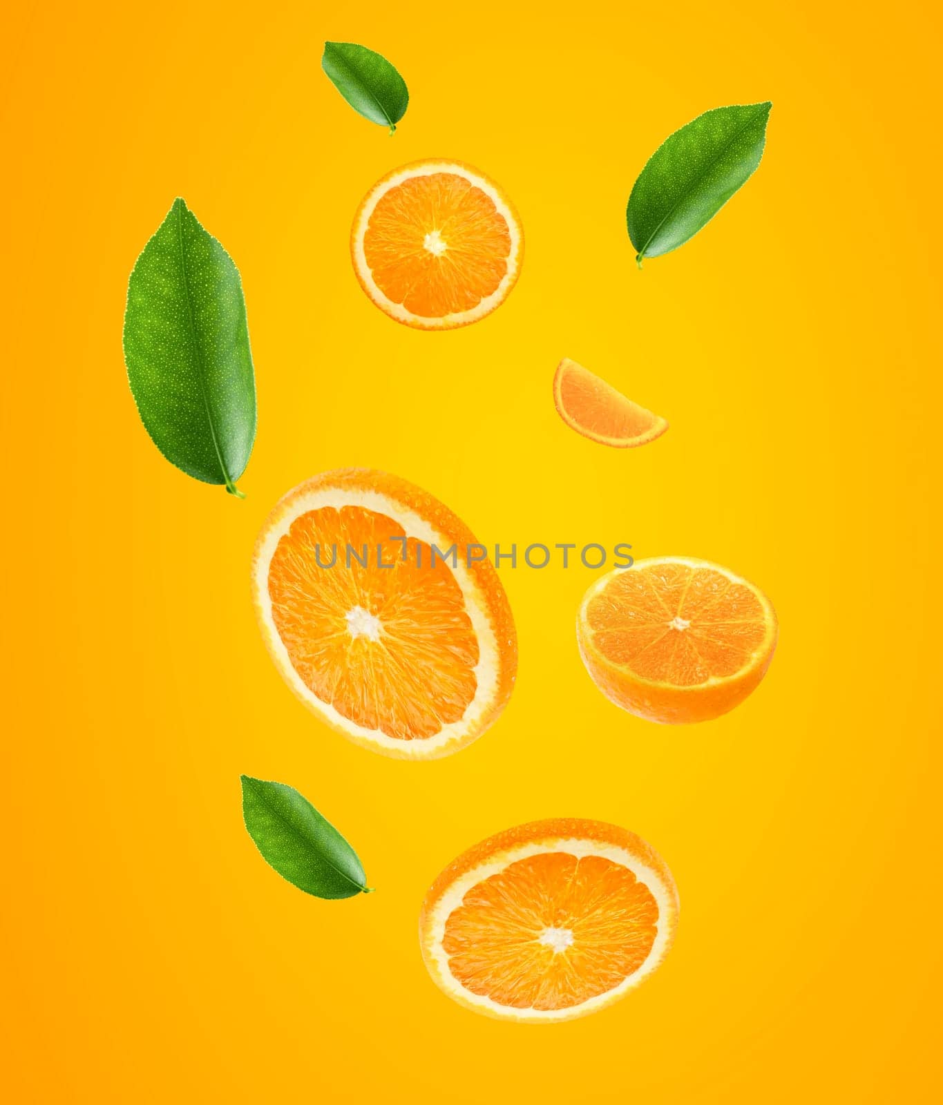 Falling juicy oranges with green leaves on orange background. Flying defocusing slices of oranges. Applicable for fruit juice advertising