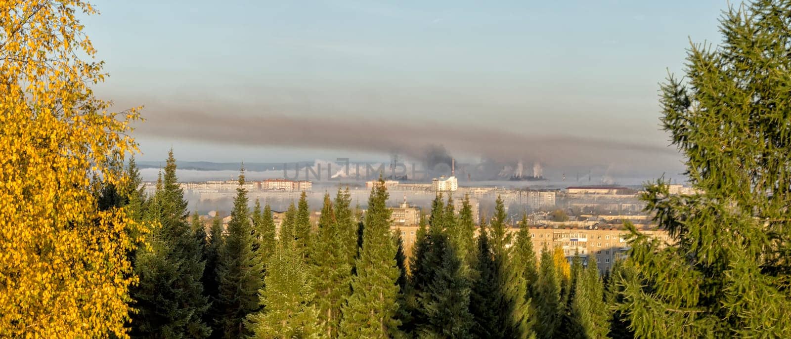 Landscape of smoking chimneys of factories in an industrial city. Dangerous ecology in the industrial city. Smoke and smog from factories and plants.