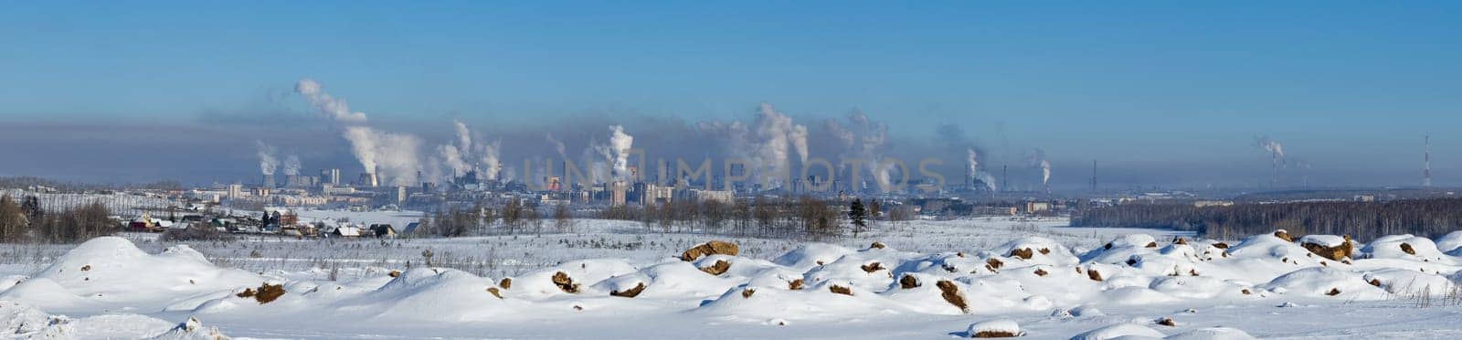 Landscape of smoking chimneys of factories in an industrial city. Dangerous ecology in the industrial city. Smoke and smog from factories and plants.