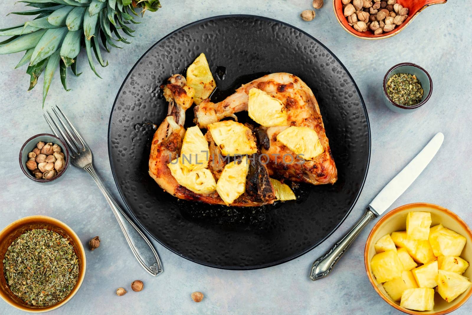 Chicken legs fried with pineapple pieces. Grilled chicken meat. Copy space.
