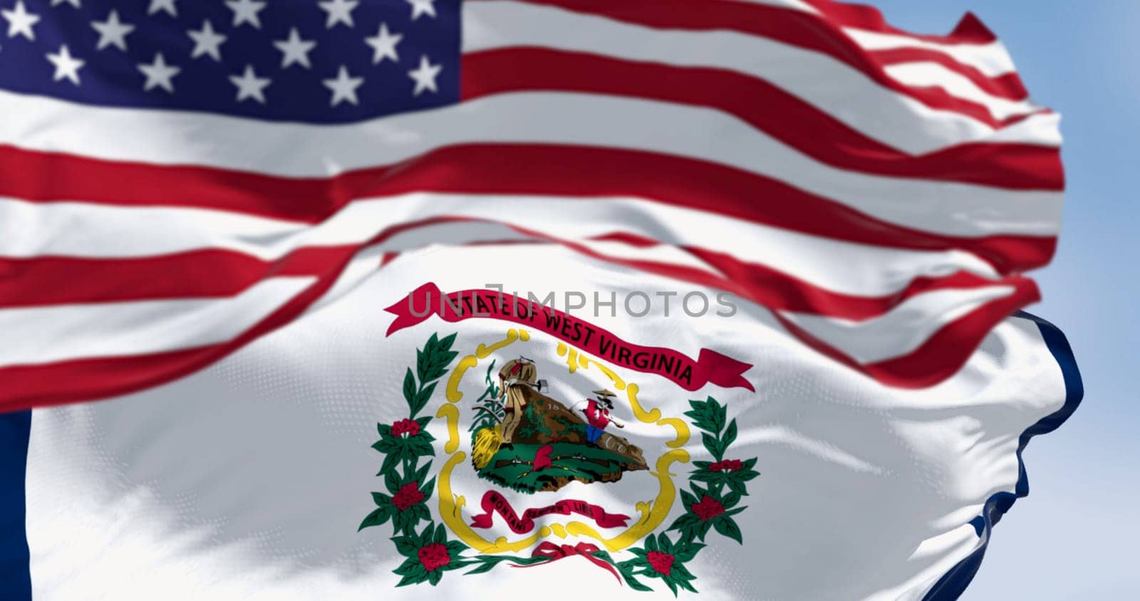 Close-up of West Virginia state flag waving in the wind with the american flag on a clear day. 3d illustration render. Fluttering fabric. Selective focus