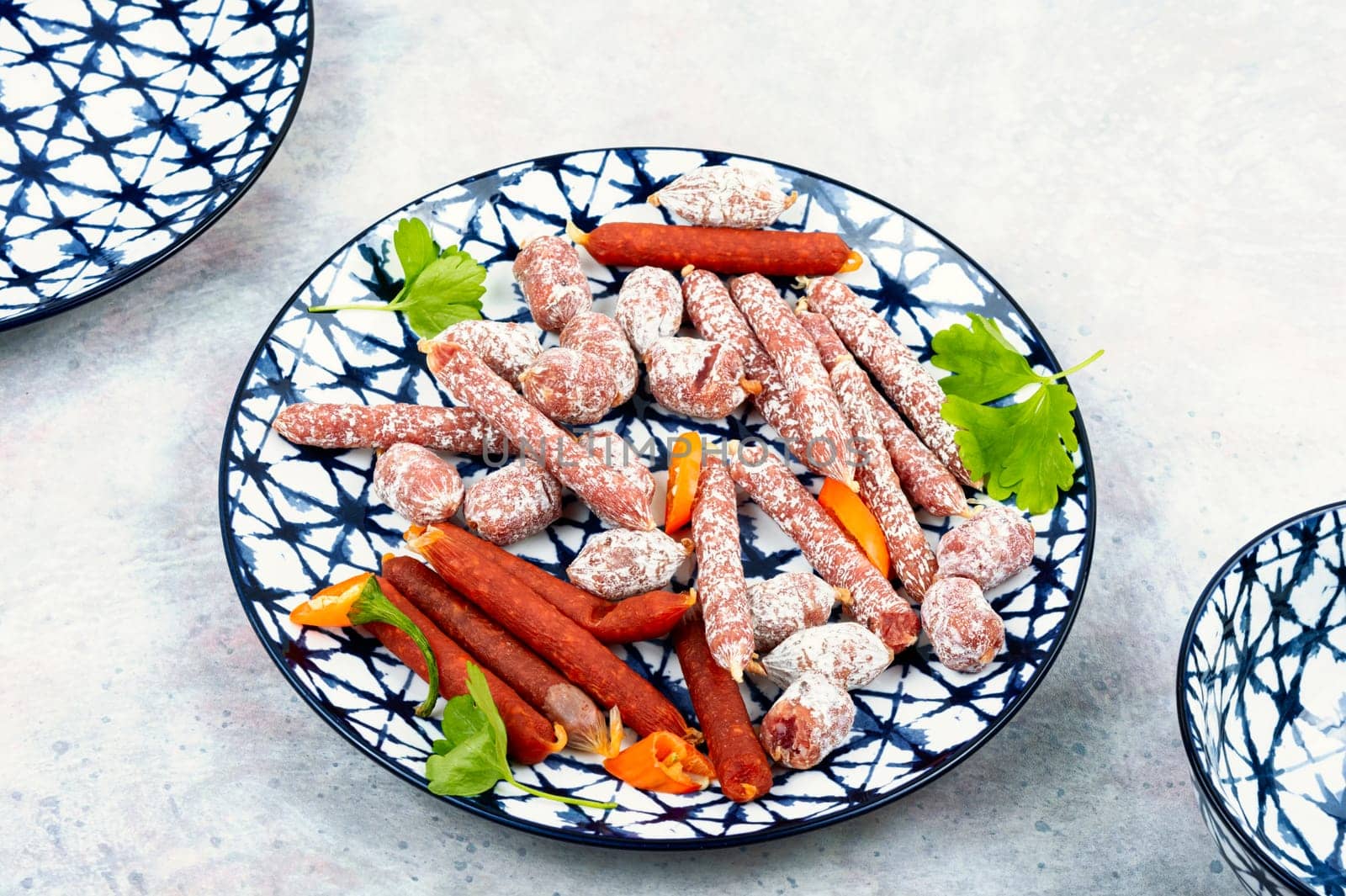 Traditional smoked thin salami on a plate, snacks for beer.