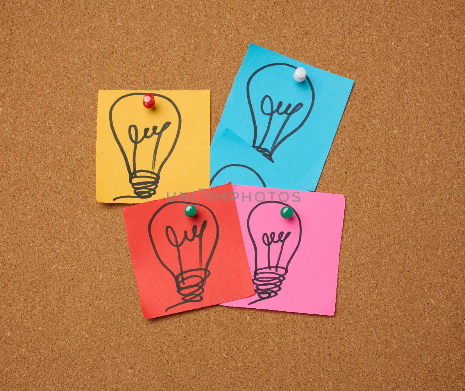 Drawn electric lightbulbs on paper sheets, signifying the concept of searching for new ideas