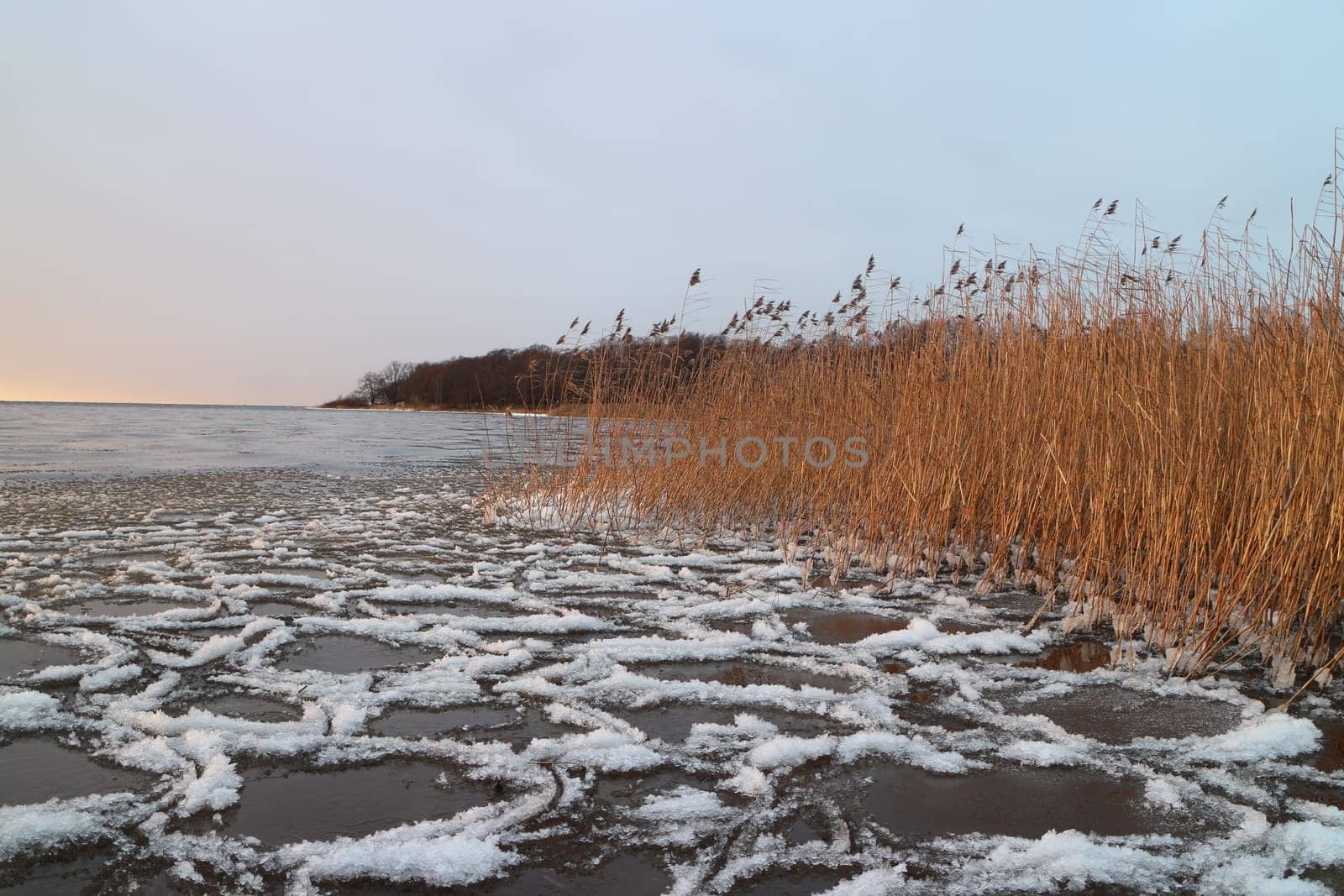 ice and white slush swaying on the surface of the lake, winter landscape