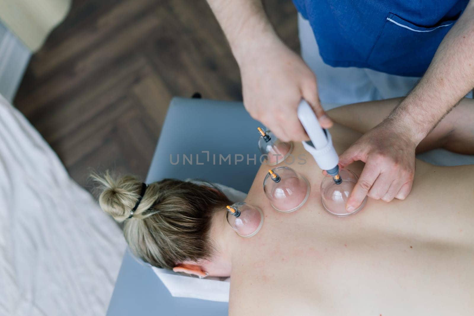 A woman does a hip massage with vacuum jar for an anti-cellulite massage.