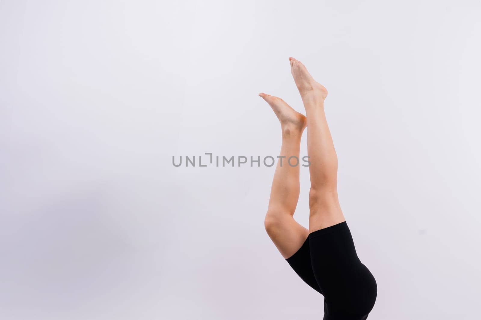Beautiful woman doing Lotus of Padmasana or Kamalasana pose on a yoga class. Studio shot.