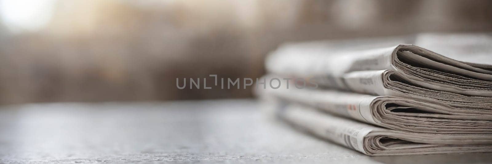 Stack of newspapers on the table in the morning light. Selective focus. Media news concept. AI generated
