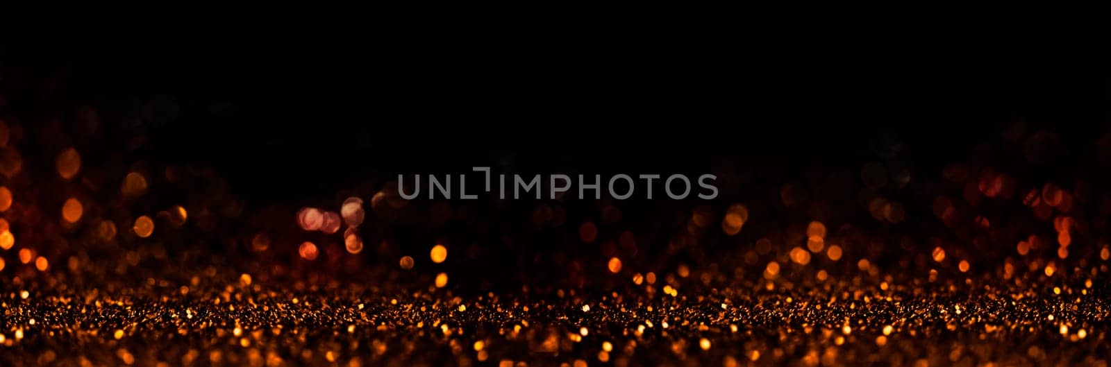 Abstract blur golden glitter on black background. Card for new year, christmas and wedding celebration. Party bokeh sparkle confetti textured layout. Classy elegant design.