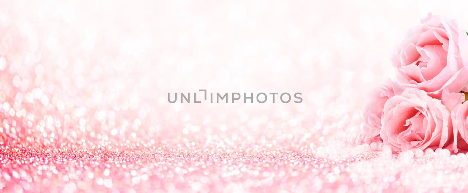 Pink roses bouquet and pearls on abstract blur pastel background. Wedding flowers and bright bokeh glitter backdrop. Wedding, bridal, valentines and mothers day celebration design.