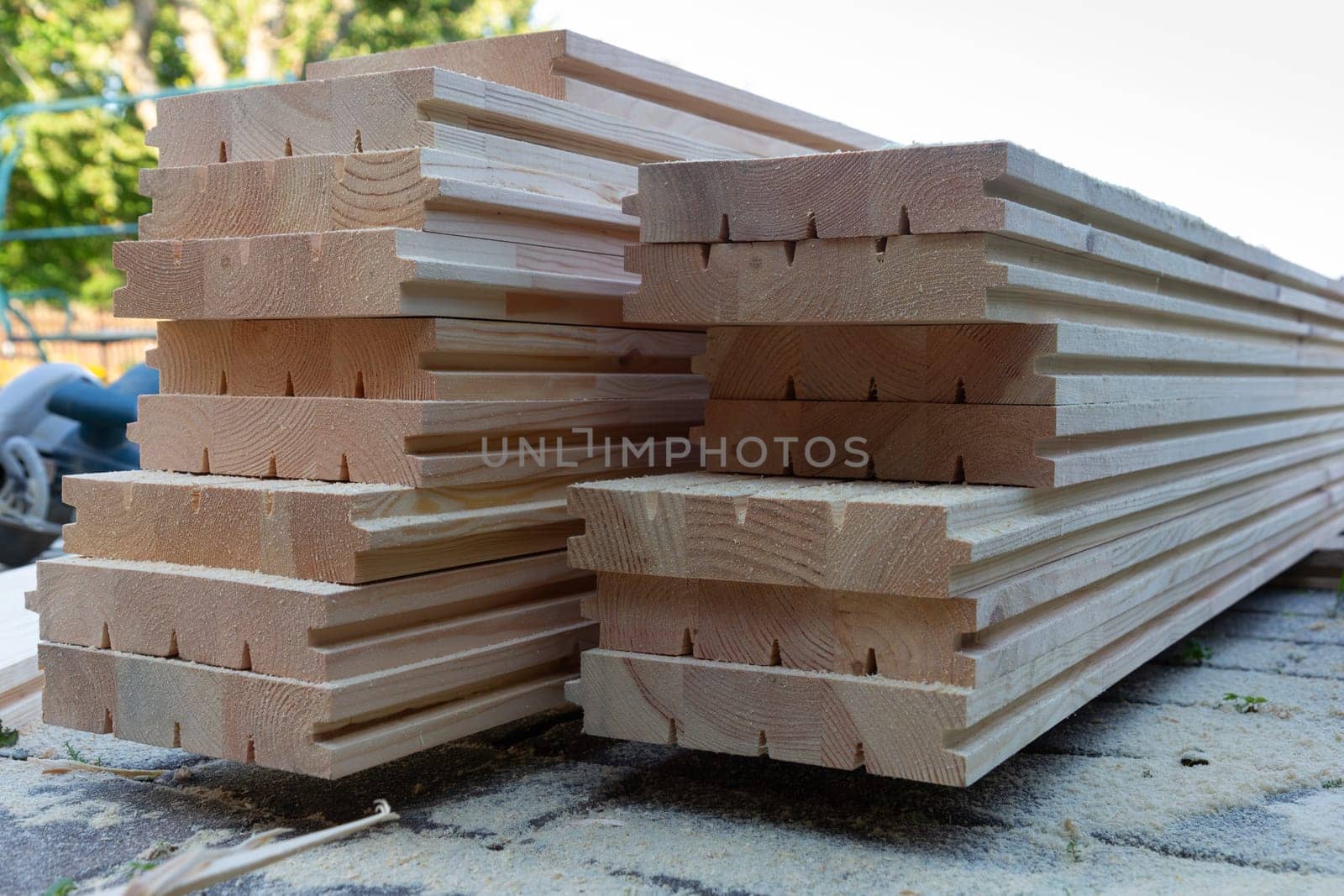 A pile of new wooden floorboards