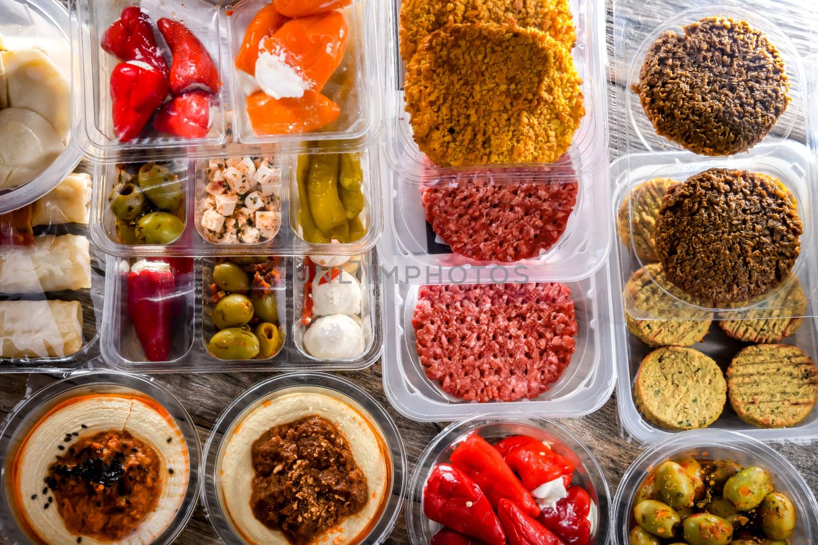 A display of variety of prepackaged food products in plastic boxes.