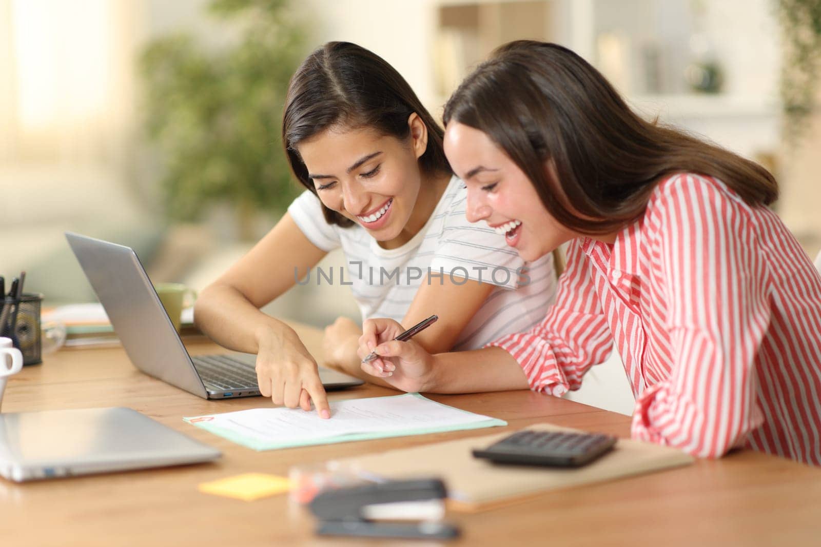 Happy workers checking document policies before sign working at home
