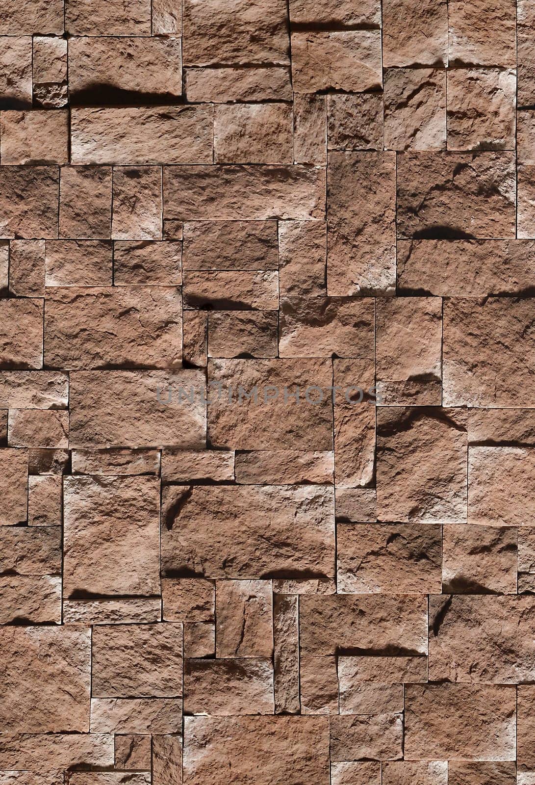 Decorative stone in the form of a sharp bumpy tile brown .Texture or background.