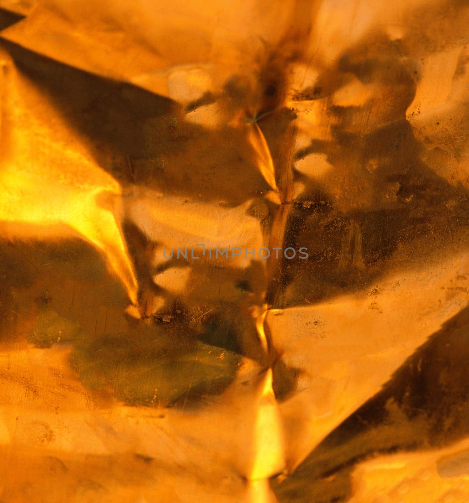 Strongly crumpled gold-colored foil.Texture or background.