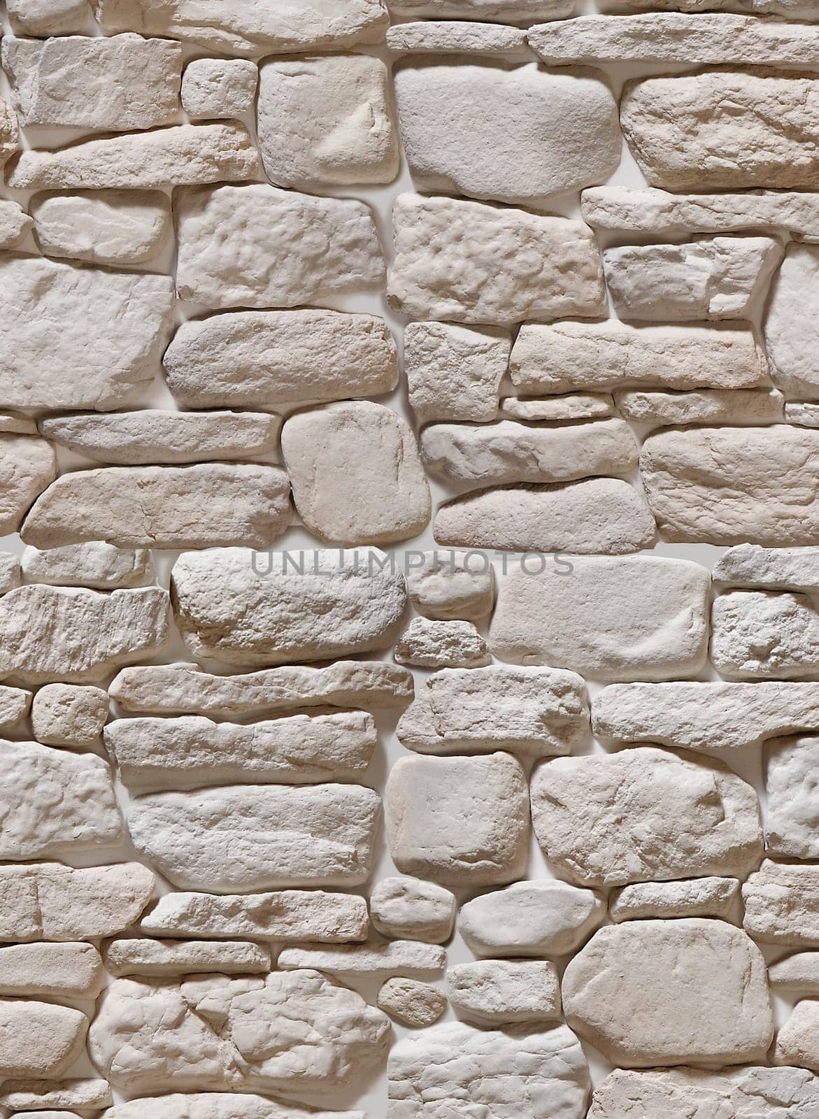 The wall is made of artificial stone in the form of a round beige cobblestone. Texture or background.