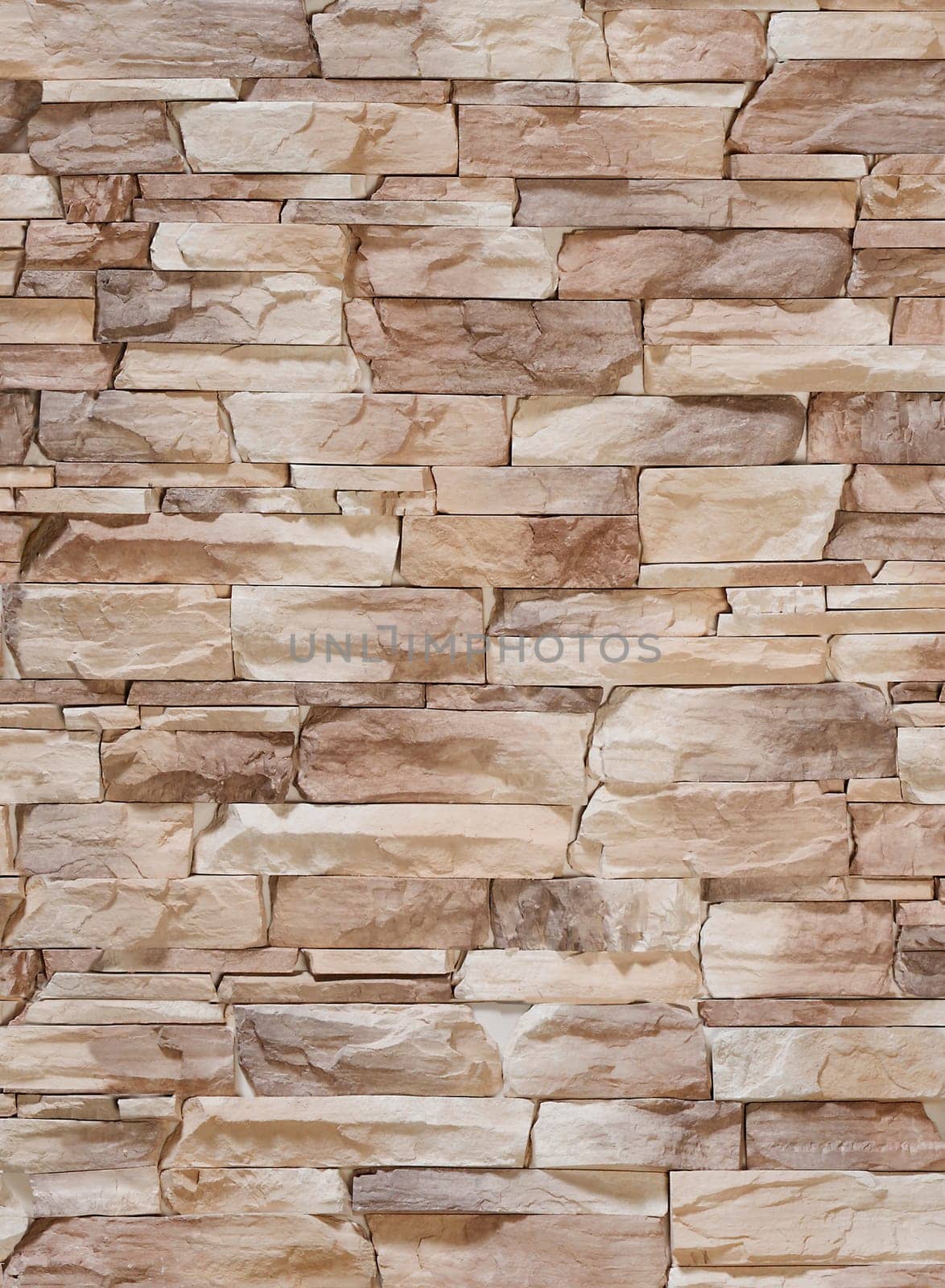 Artificial stone in the form of sharp uneven tiles of brown color.Texture or background.