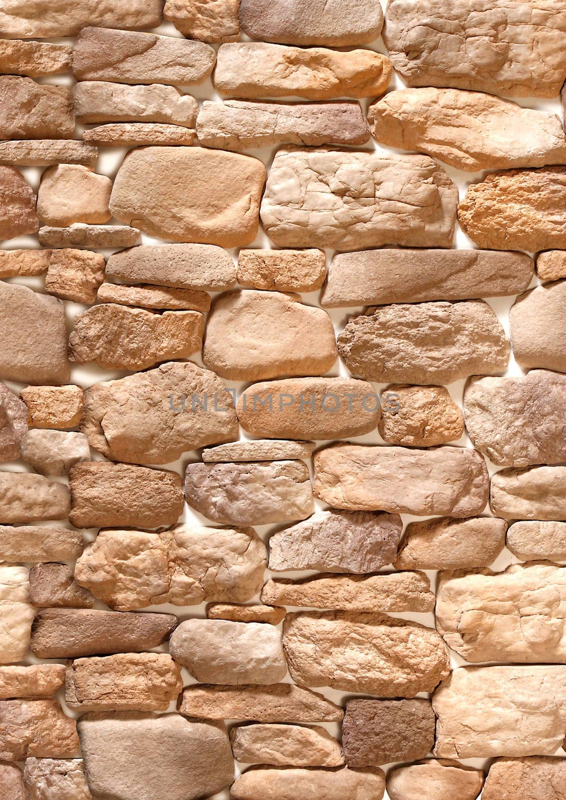 Decorative convex overlay made of stone in the form of brown cobblestones .Texture or background.