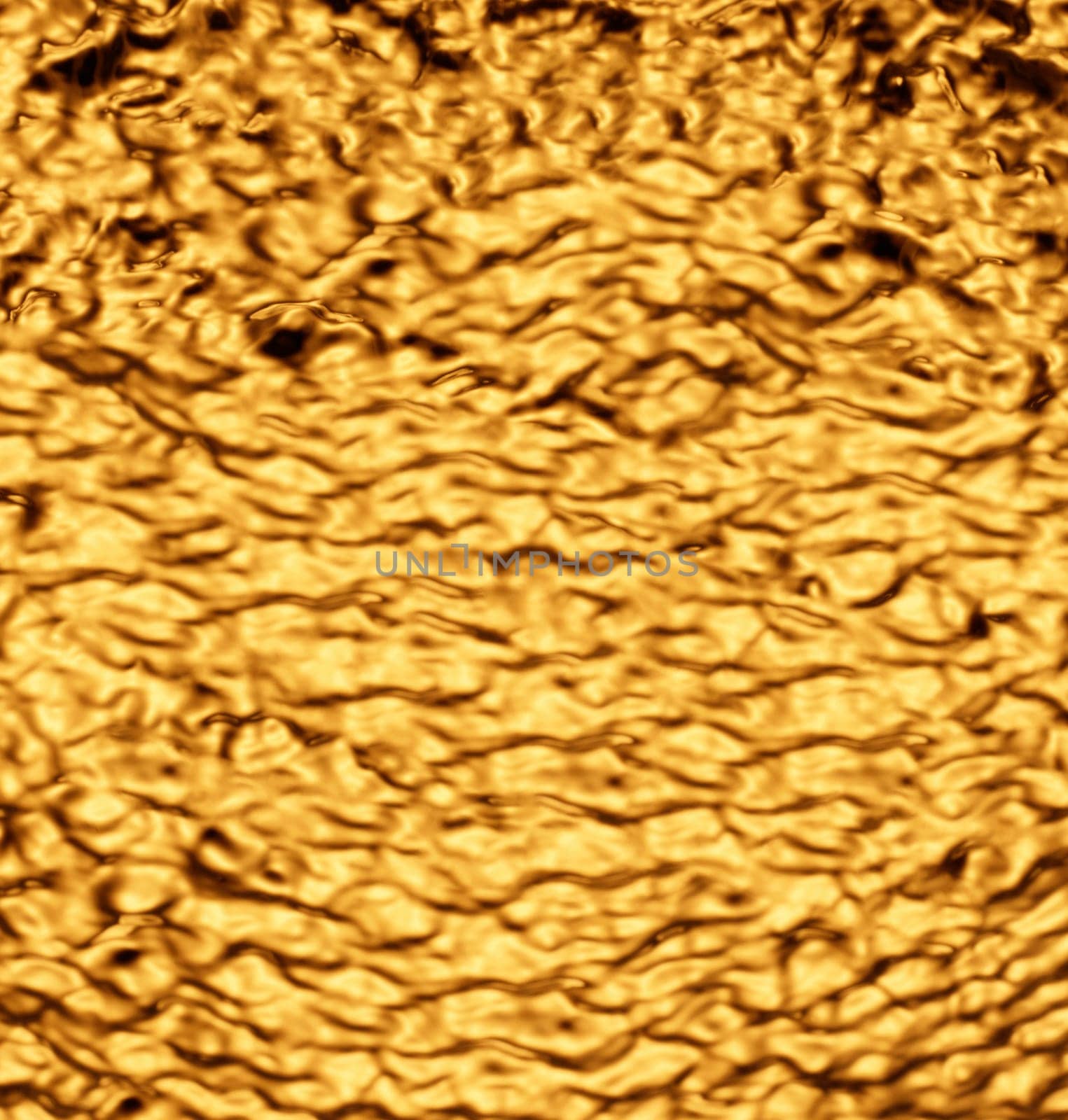 Heavily crumpled gold-colored metal sheet.Texture or background.